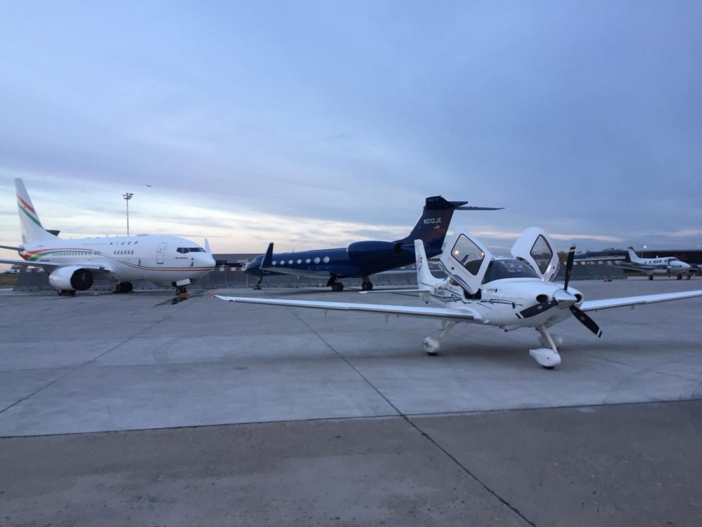 Cirrus SR22 aircraft for private flights next to propeller planes