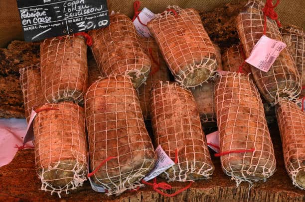 Whole lonzi in close-up on a market stall in Corsica, take a private jet to Bastia 